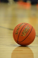 A spalding legacy basketball rests on a polished court.