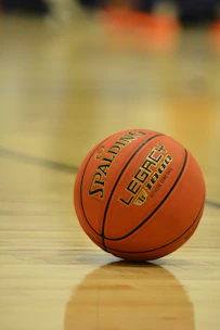 A spalding legacy basketball rests on a polished court.
