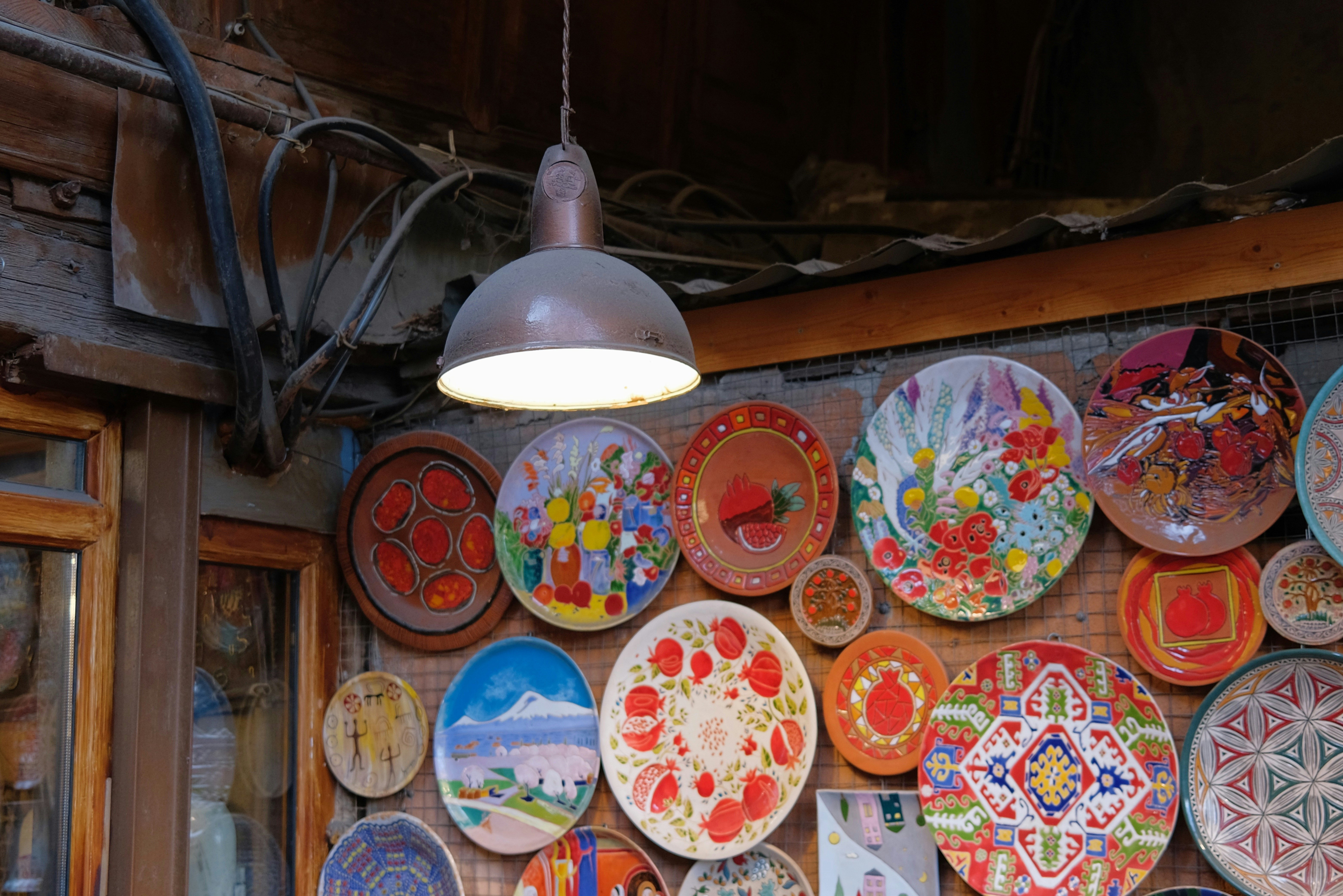 Colorful decorative plates displayed on a wall
