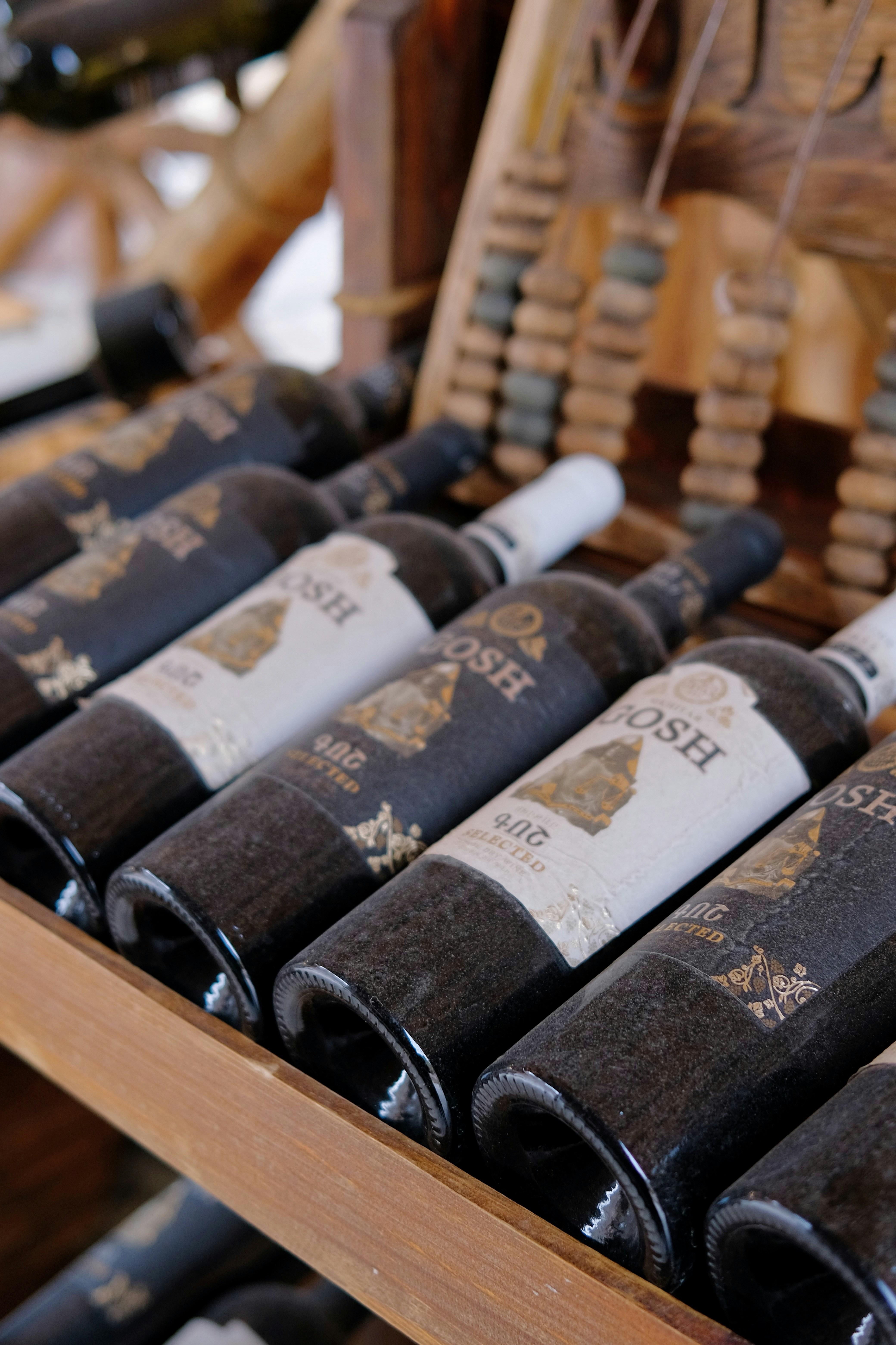 Bottles of wine stored on a wooden rack