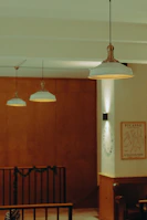 Three pendant lights hang in a dimly lit room.