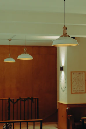 Three pendant lights hang in a dimly lit room.