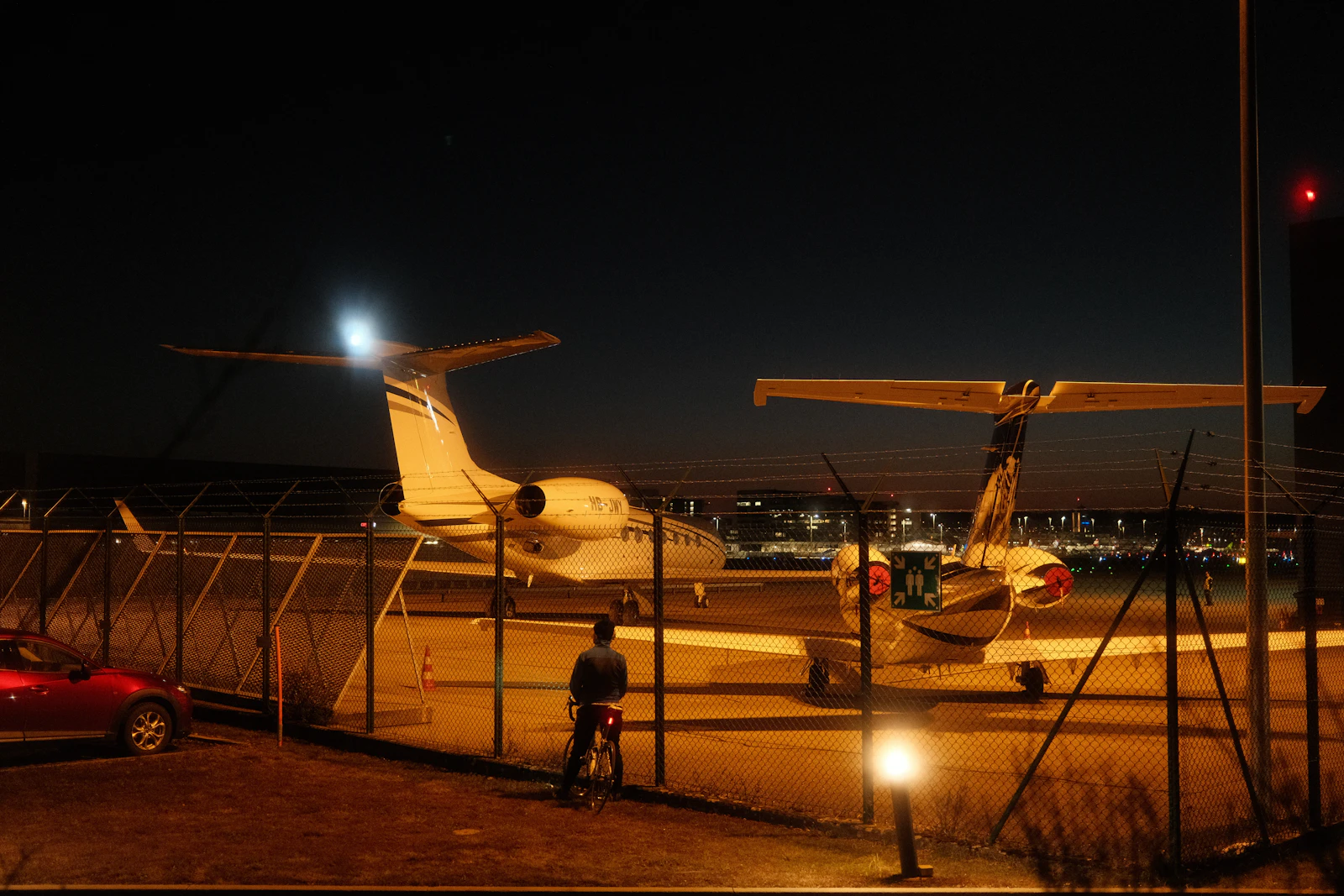 Two private jets parked at twilight