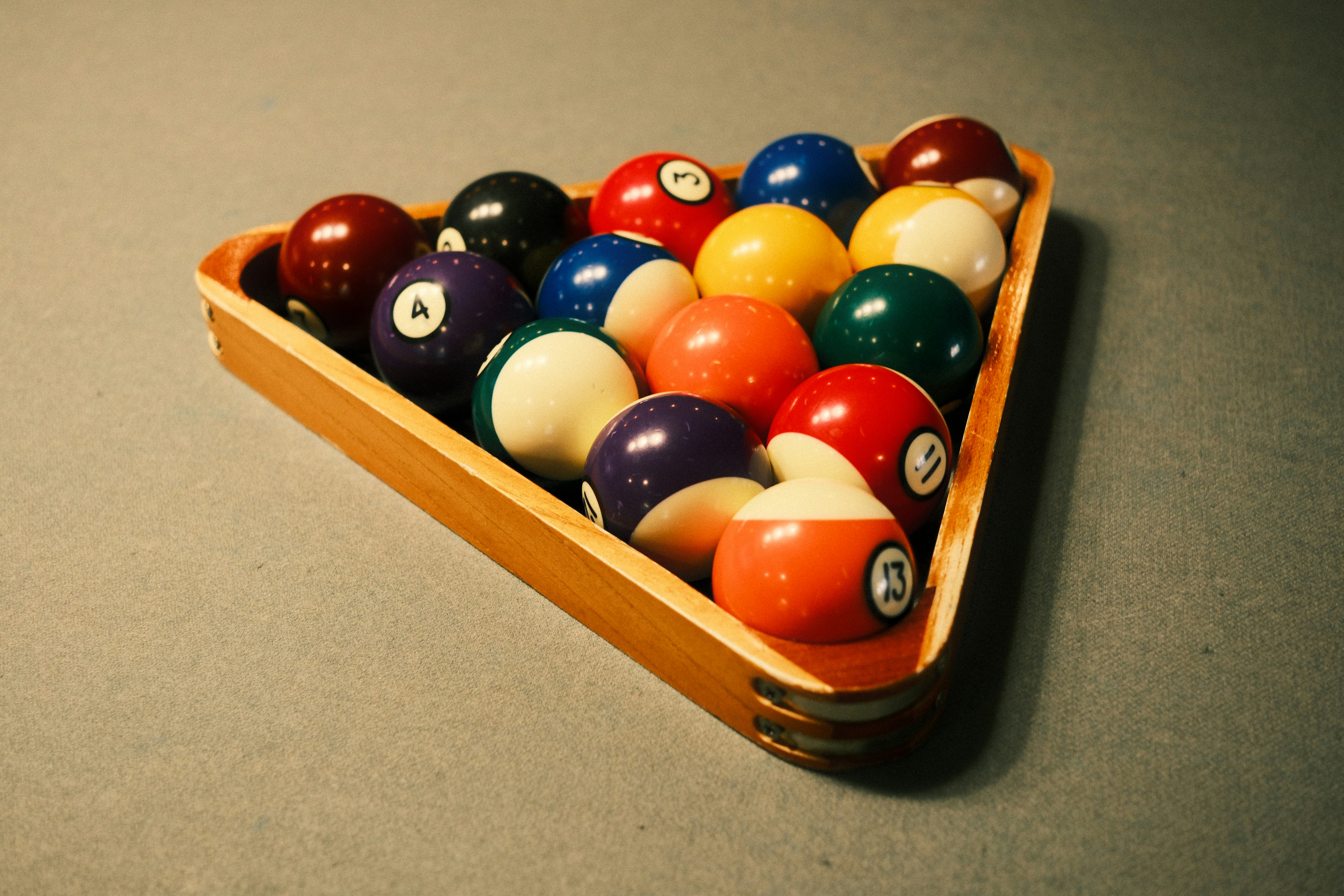 Pool balls racked in a triangle on a table.
