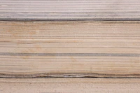 A close stack of aged book pages seen from the cut edge