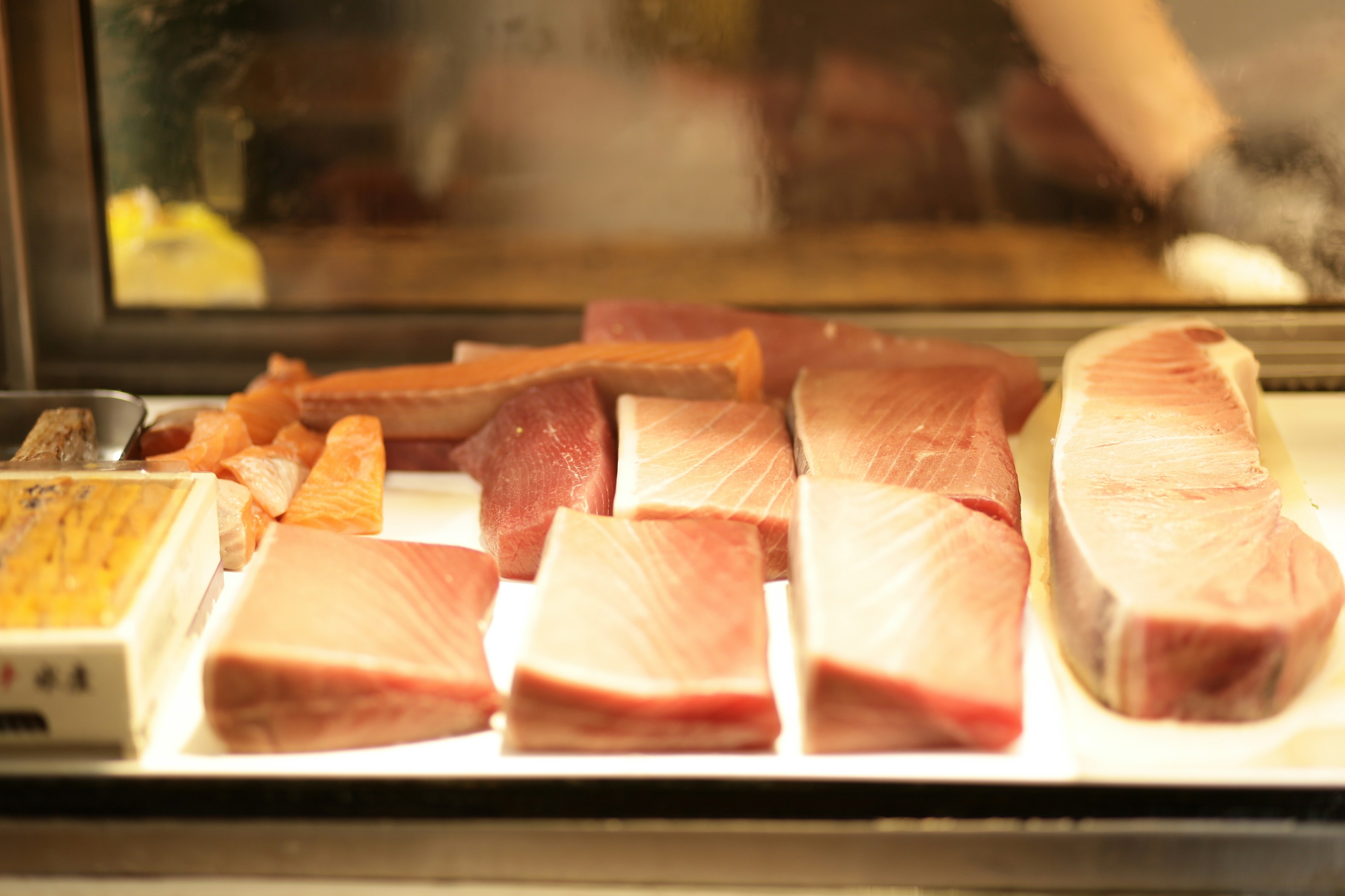 Freshly cut raw tuna steaks displayed for sale