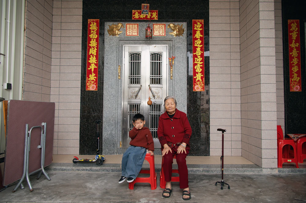 Grandmother and grandson sitting outside