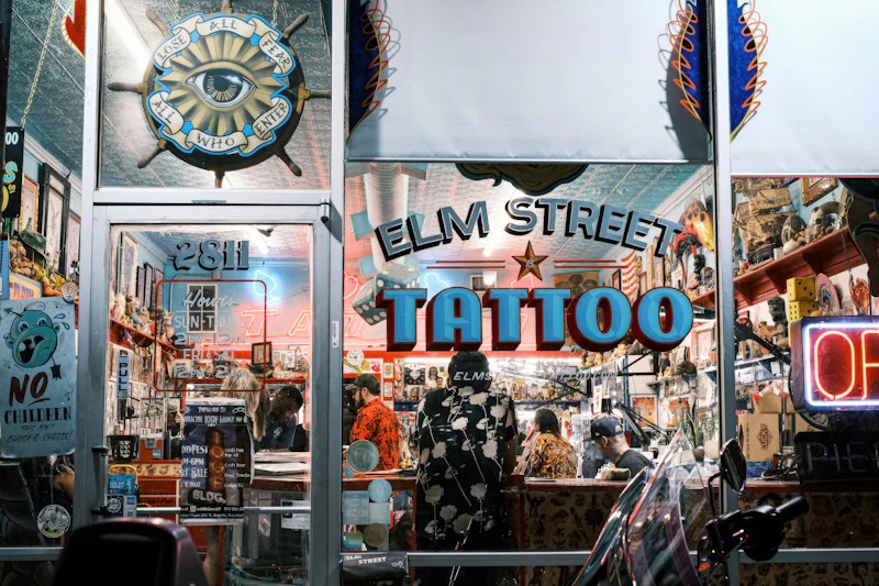 The neon storefront of Elm Street Tattoo at night in Deep Ellum, Dallas