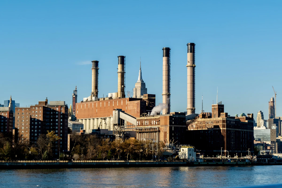 Industrial power plant with smokestacks along the waterfront, reflecting the infrastructure collapse documented in East St. Louis