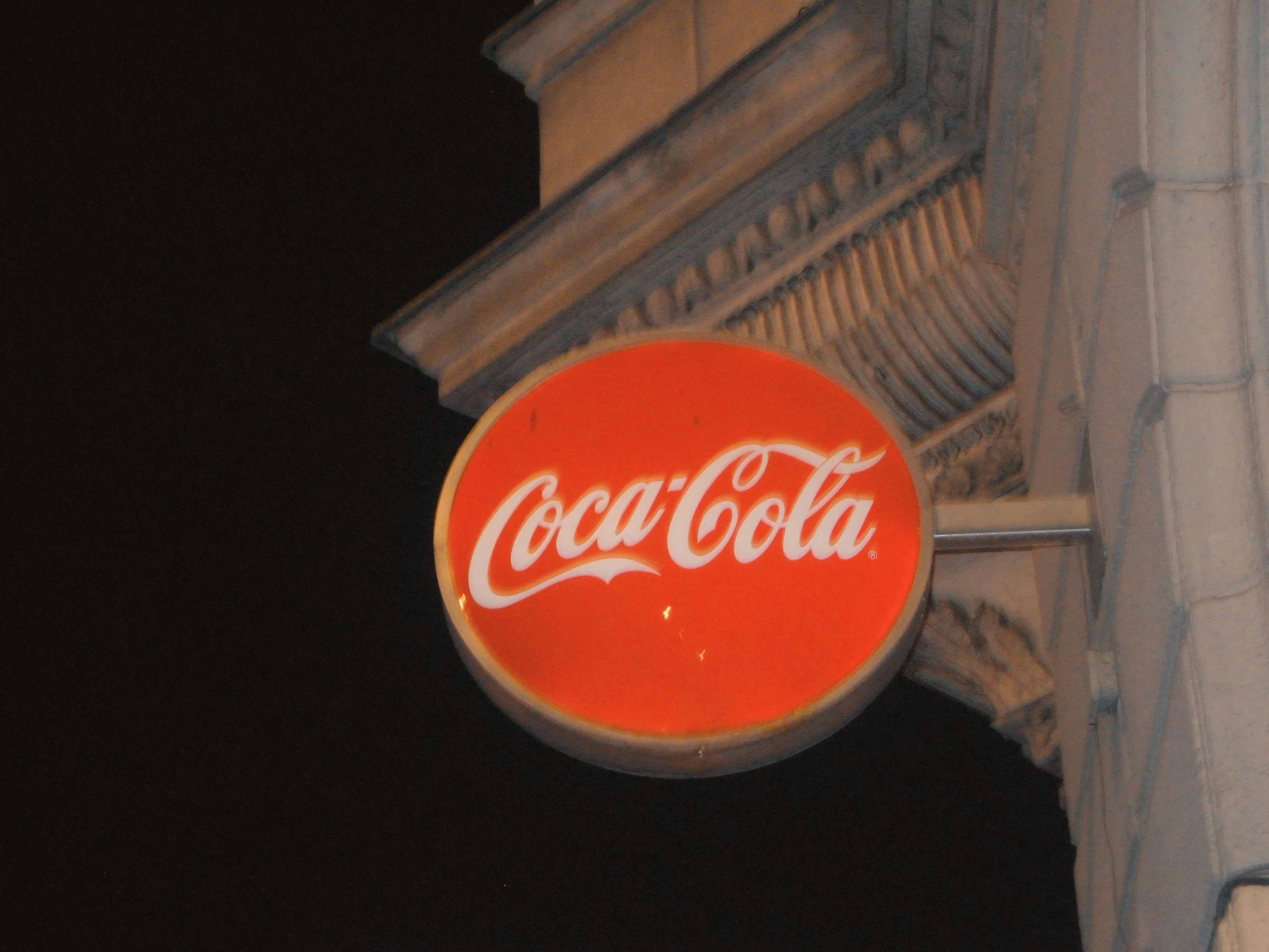 A coca-cola sign at night