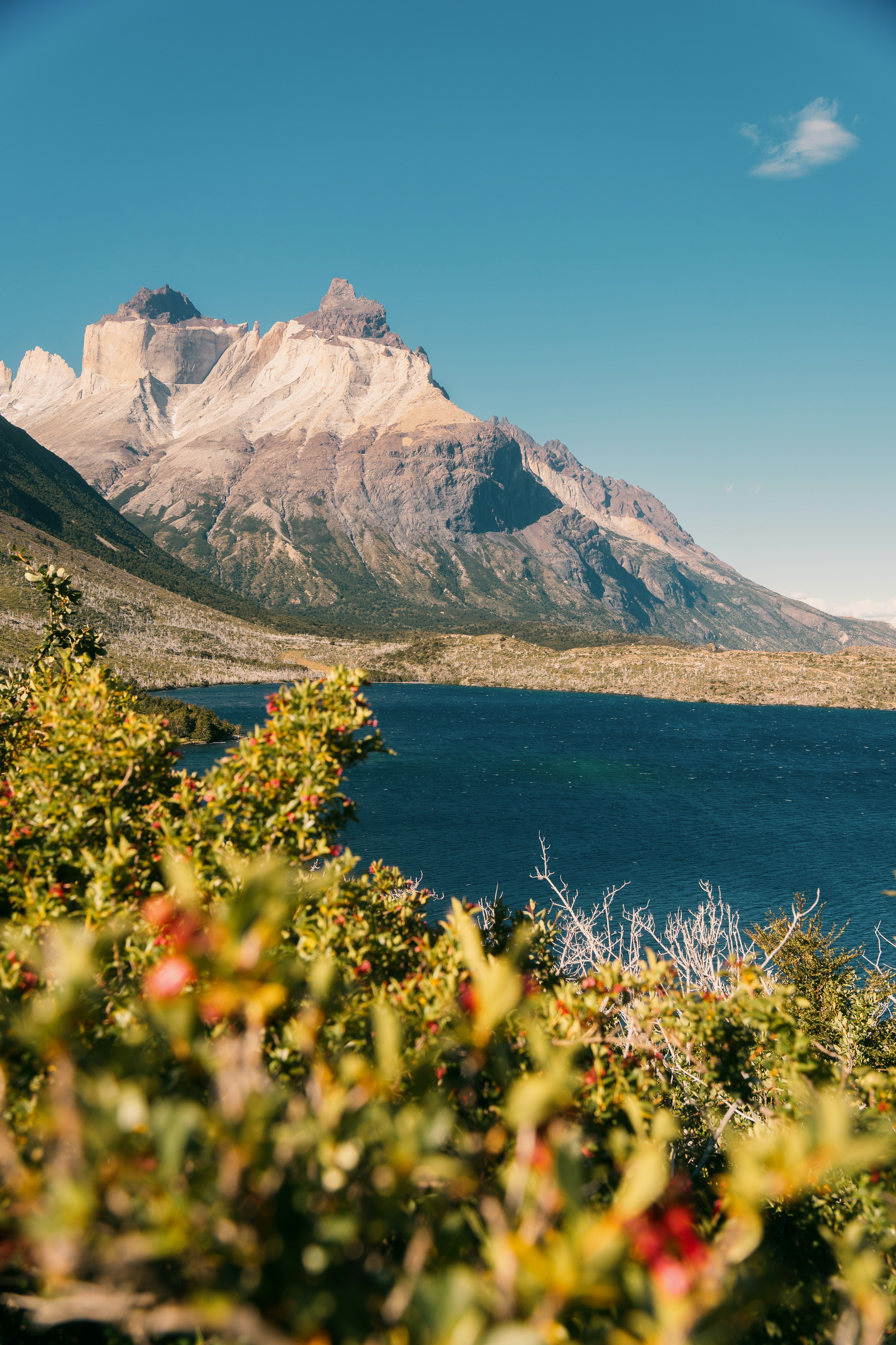 Jagged mountains rise above a dark blue lake.