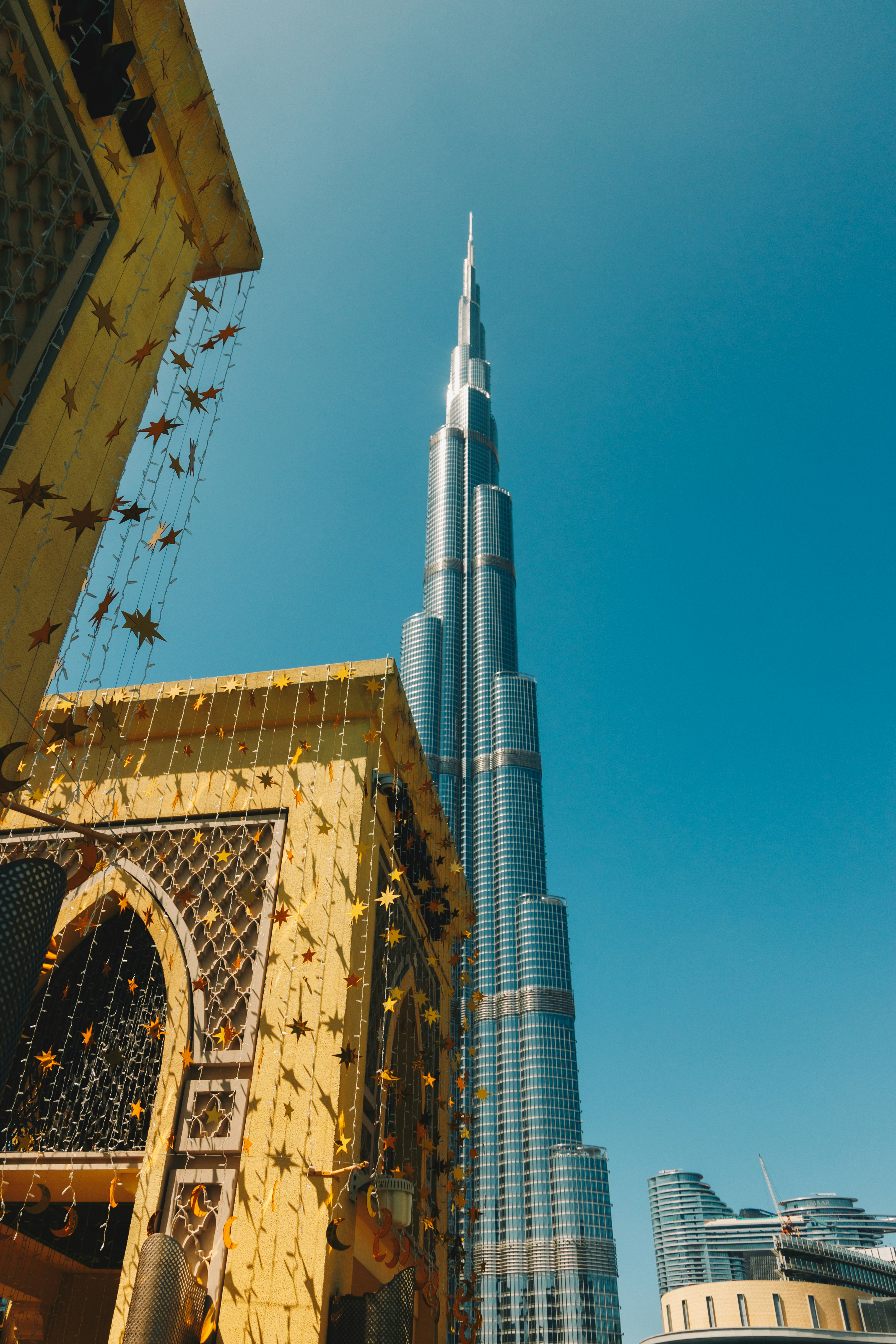 A tall skyscraper against a clear blue sky