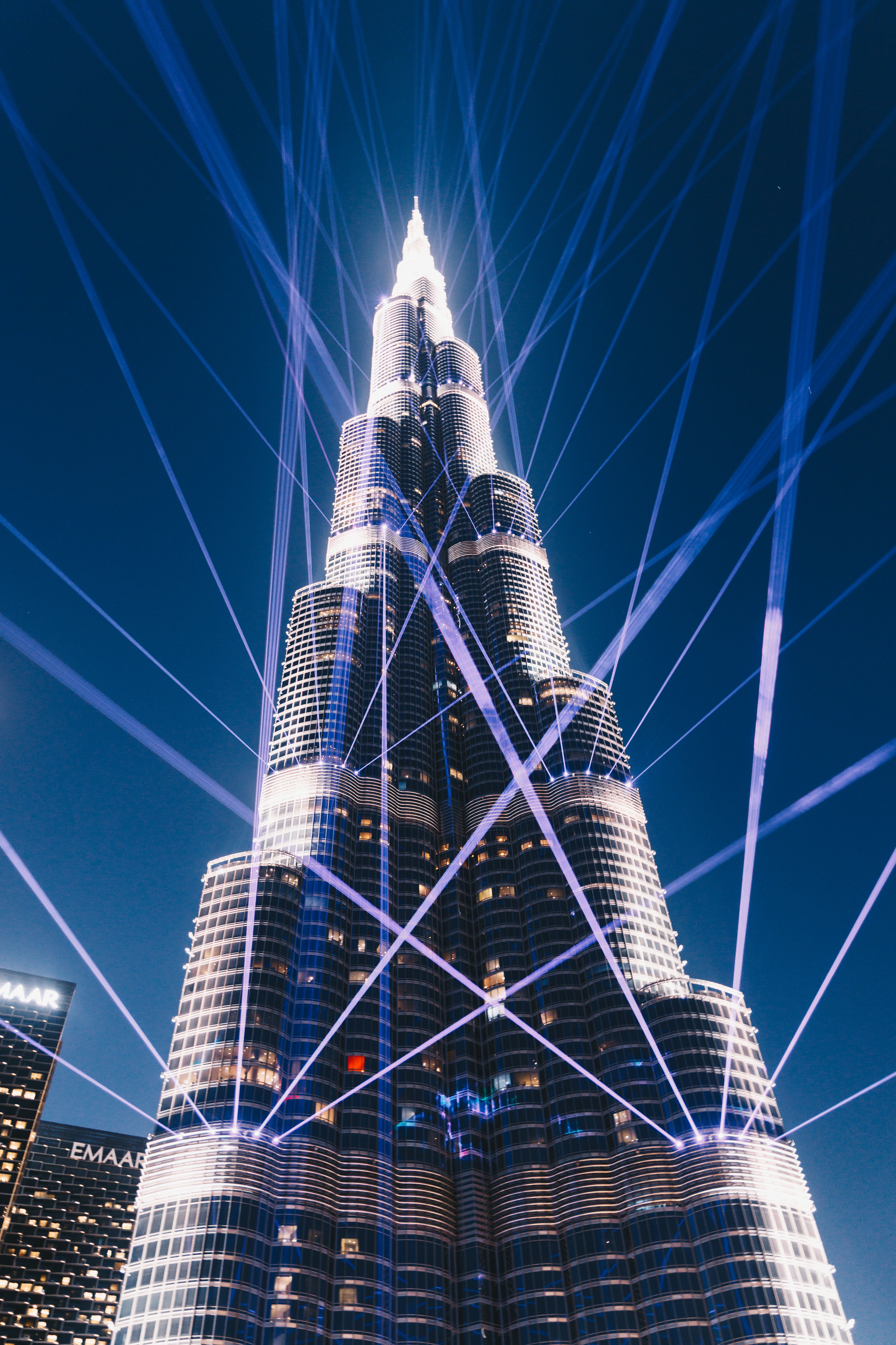 Burj khalifa illuminated with blue light beams at night