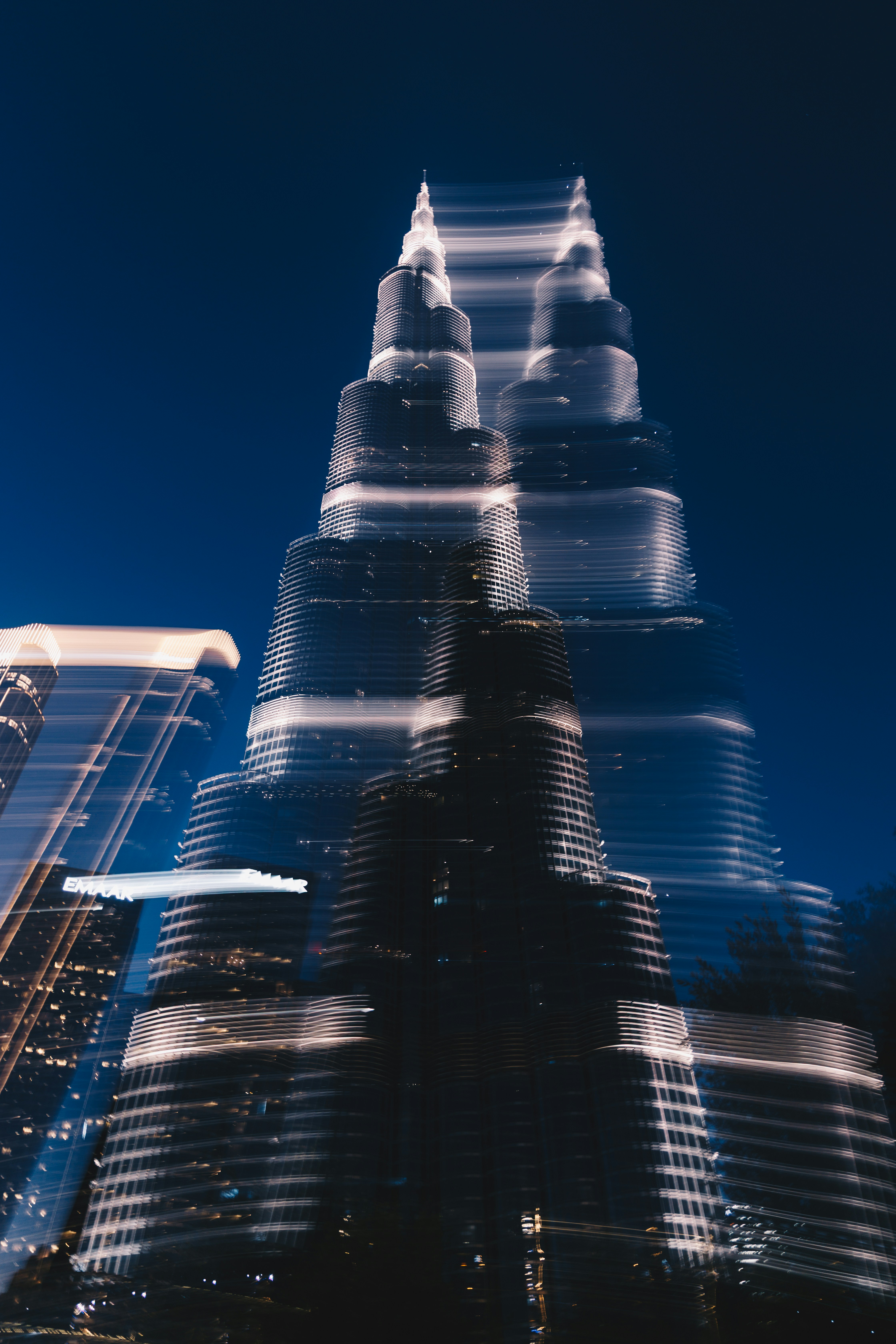 Blurry tall skyscrapers at night with city lights