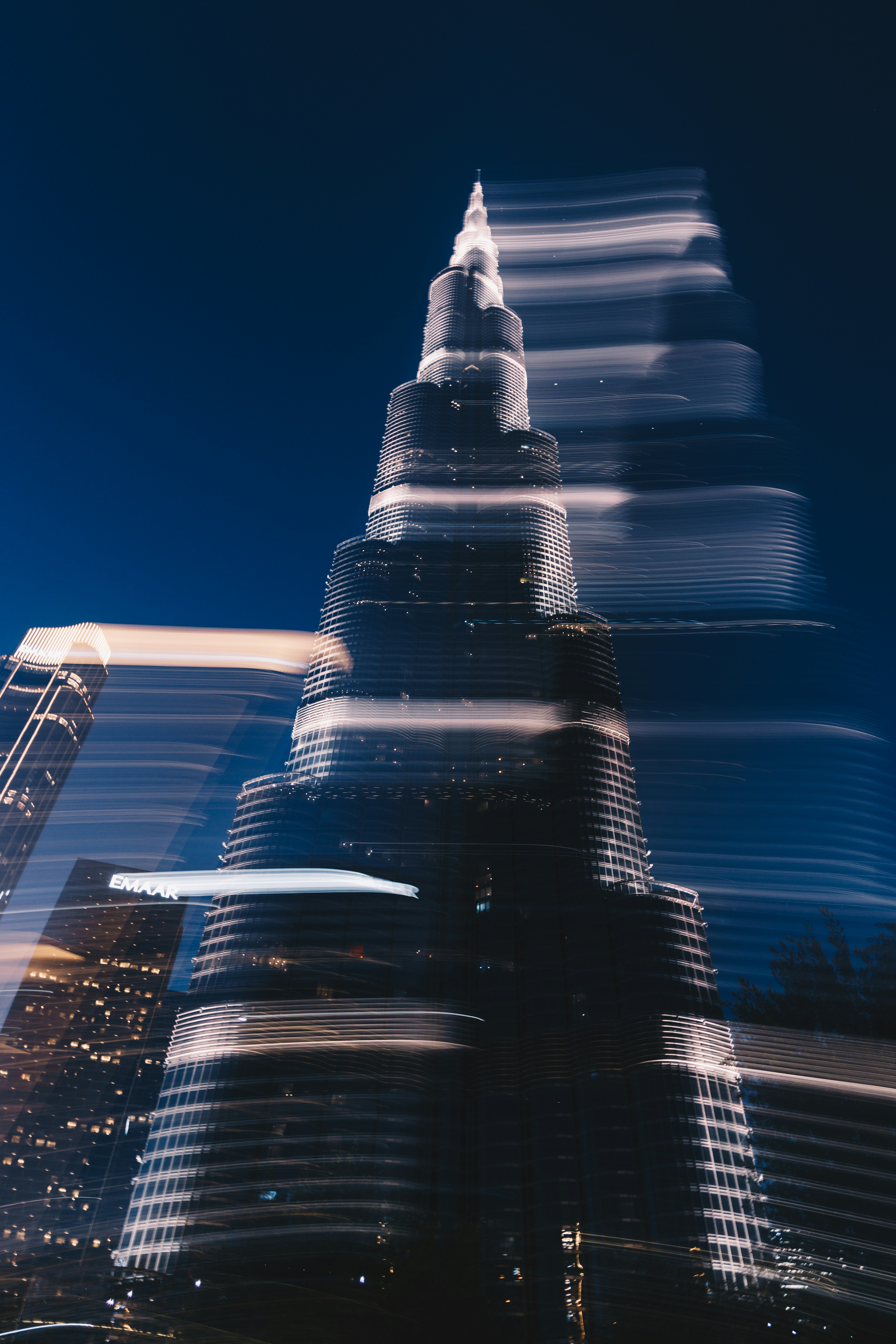 Tall skyscraper with light streaks at night