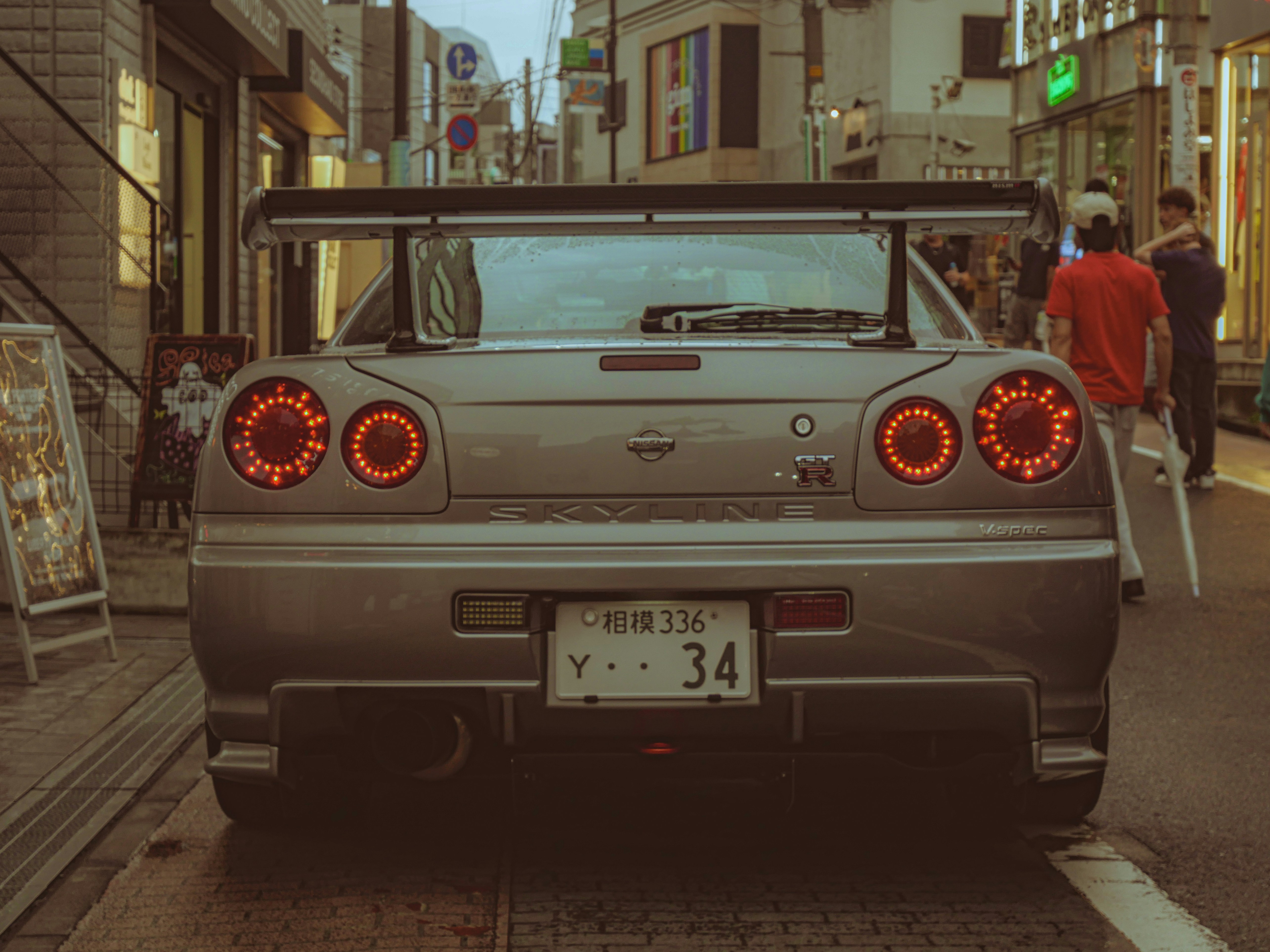 Rear view of a silver sports car with spoiler