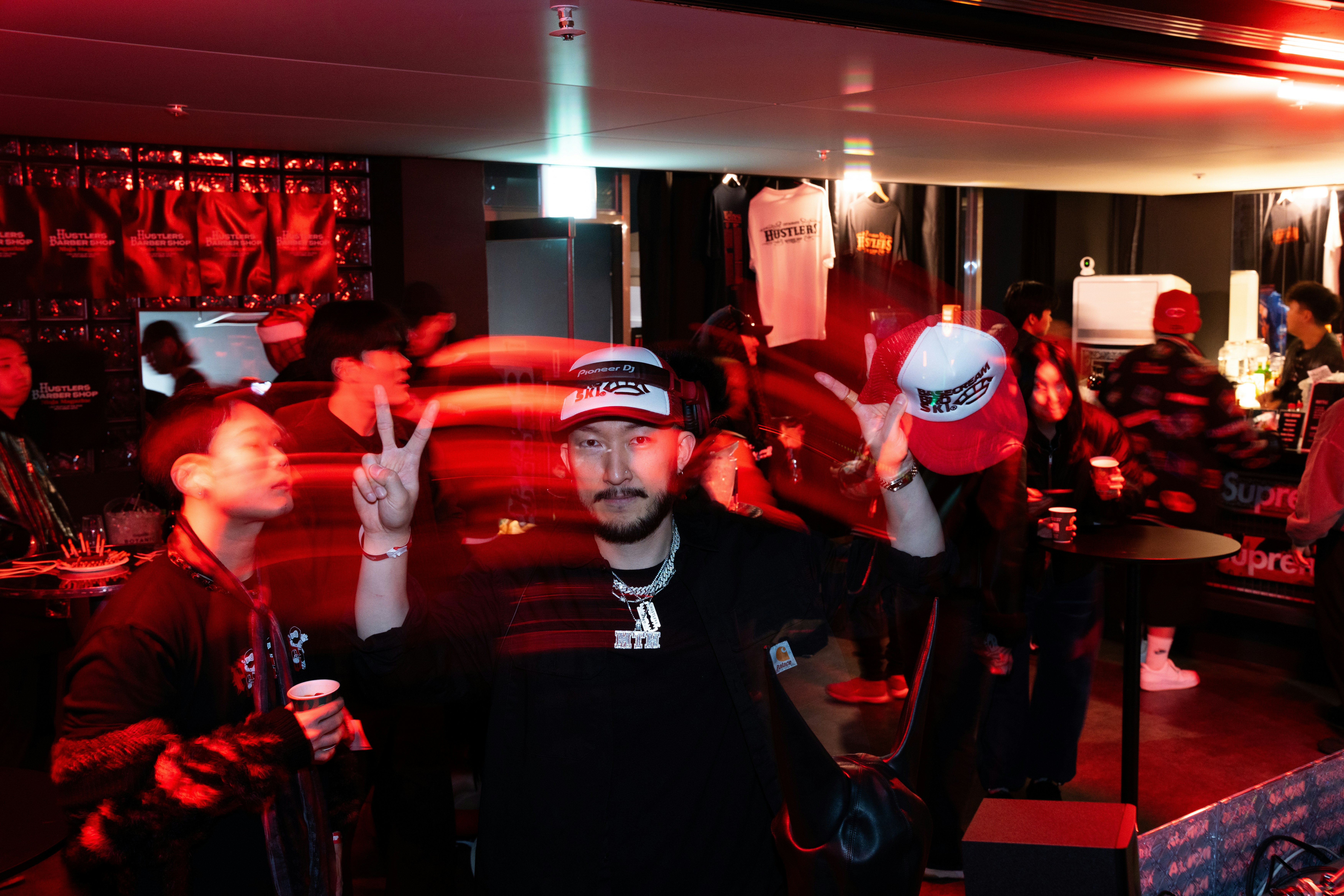 People celebrating in a dimly lit, red-lit room.