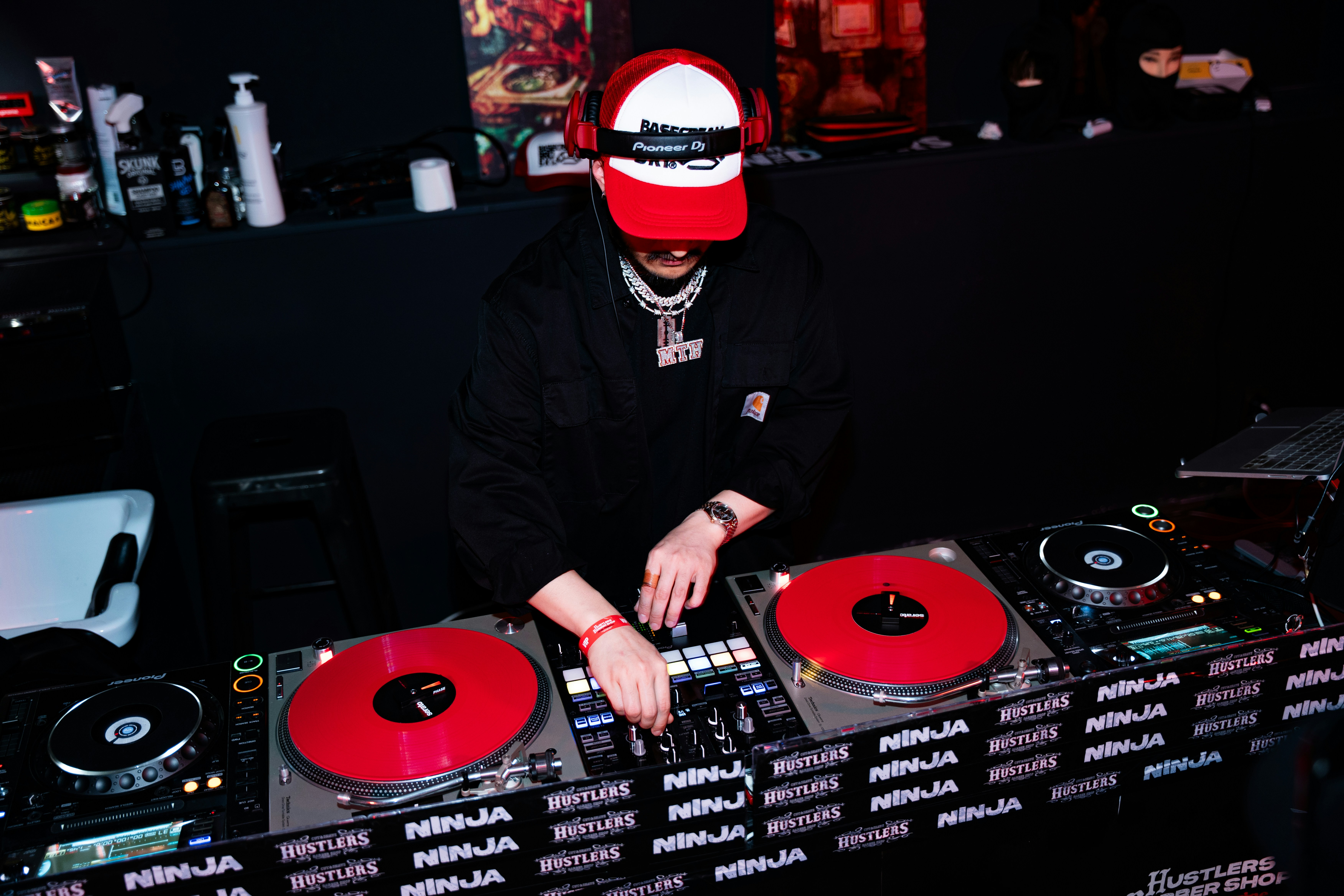 Dj playing music on turntables at a club