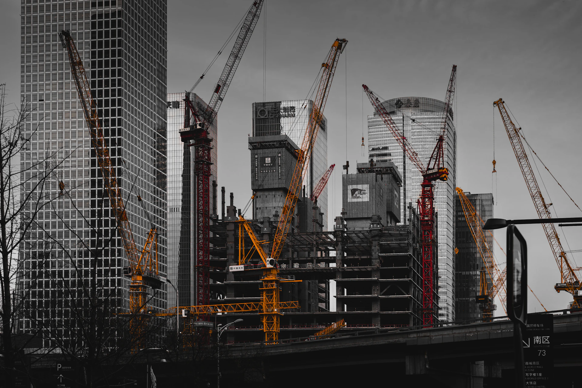 Skyscrapers and cranes at a construction site.