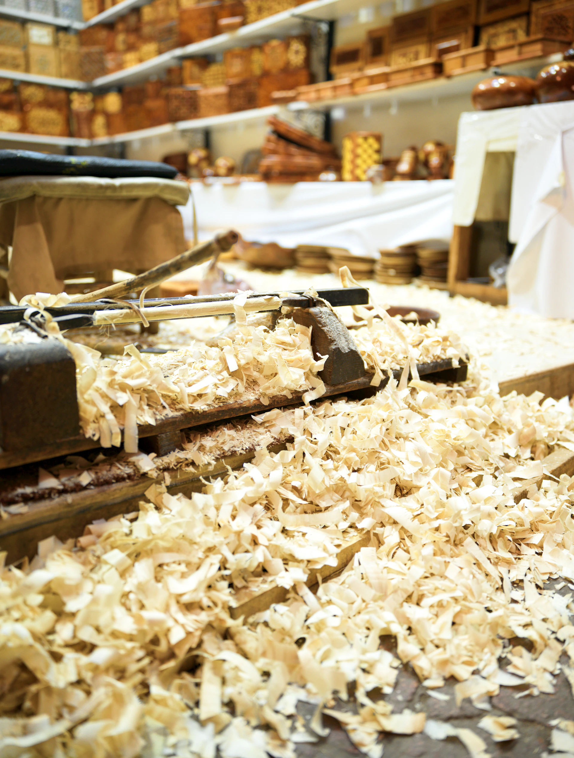 Wood shavings on a workbench with tools