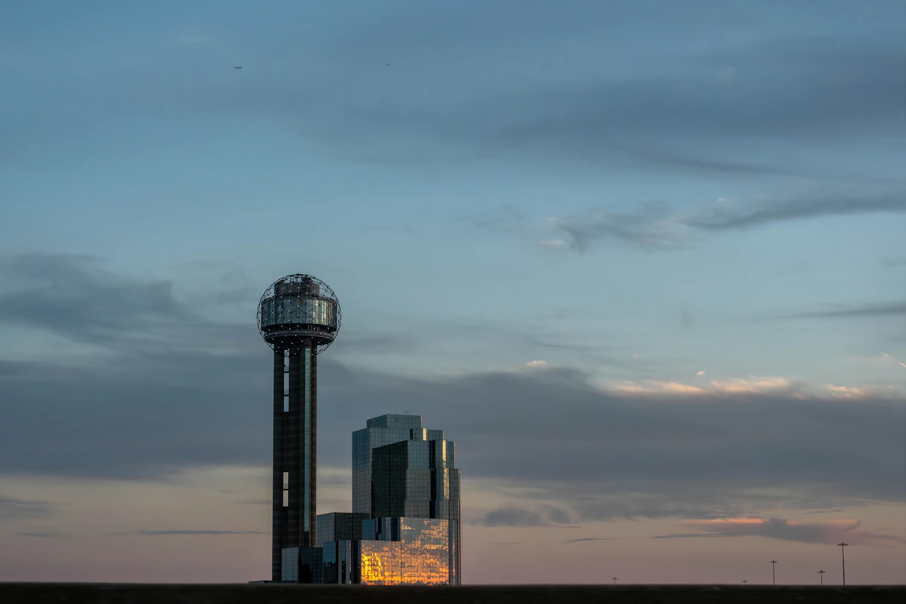 Reunion Tower and the Dallas skyline beneath a wide evening sky