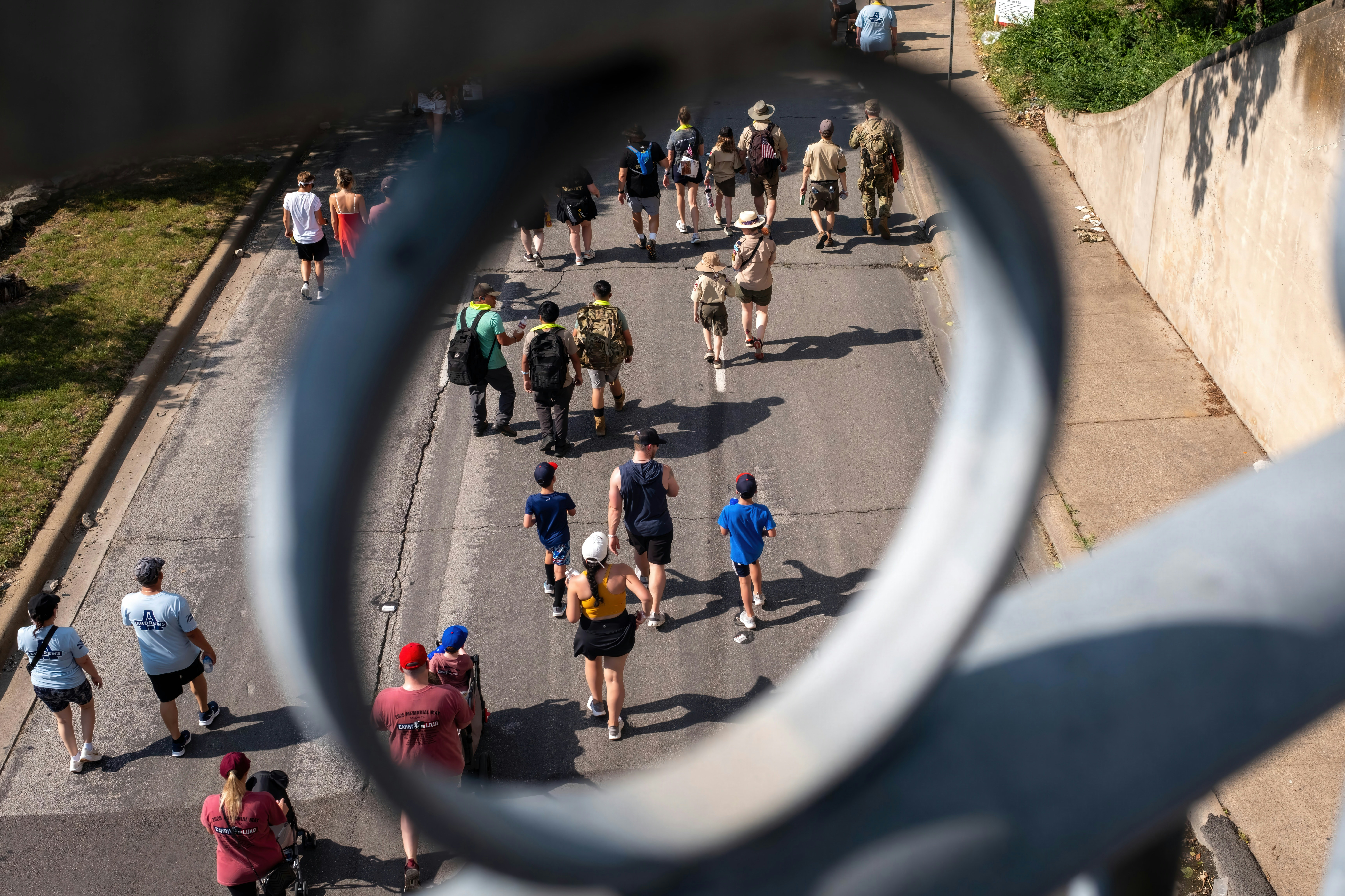 People walking on a street seen through a metal ring