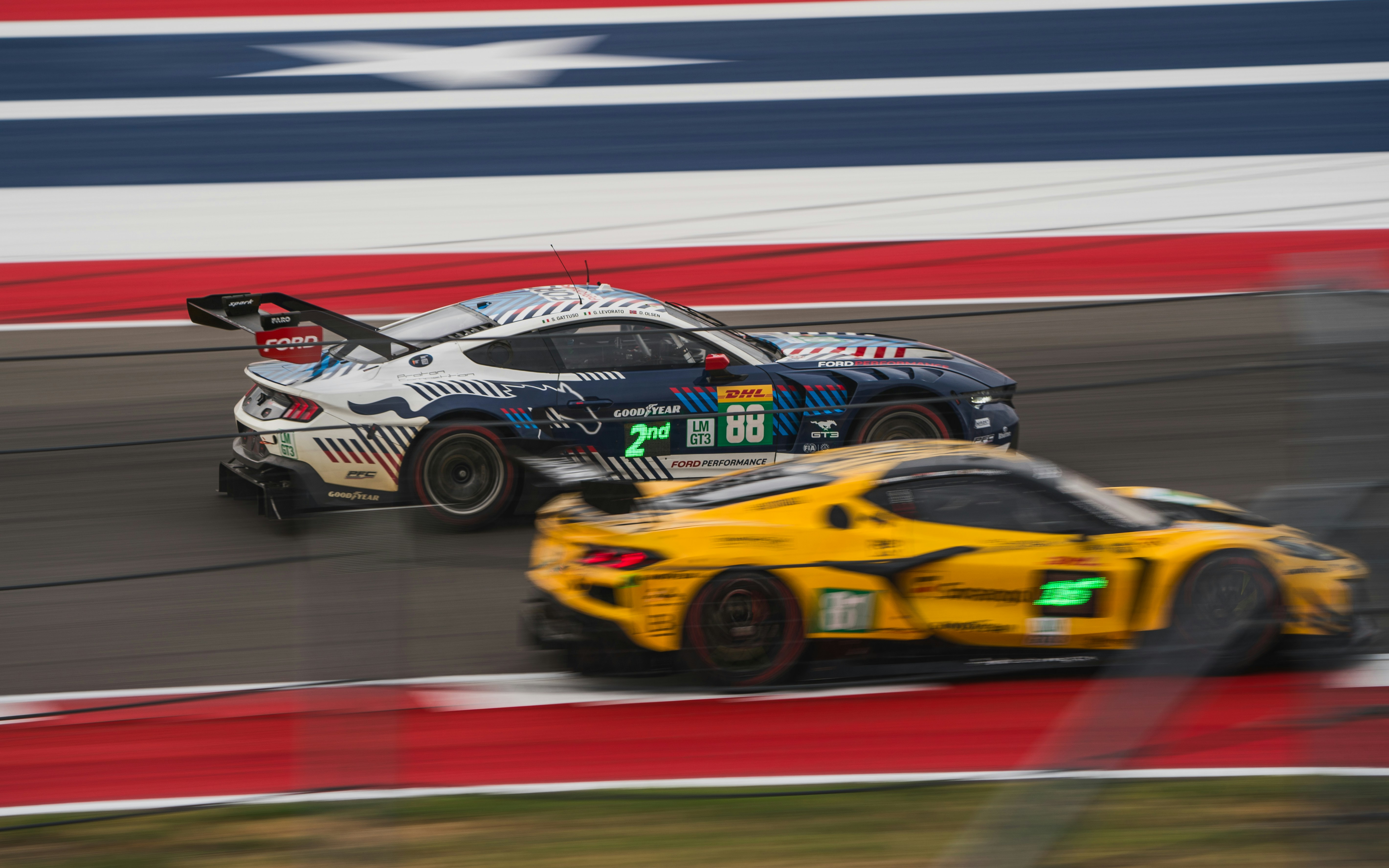 Two race cars competing on a track