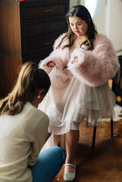Young woman with down syndrome trying on a dress