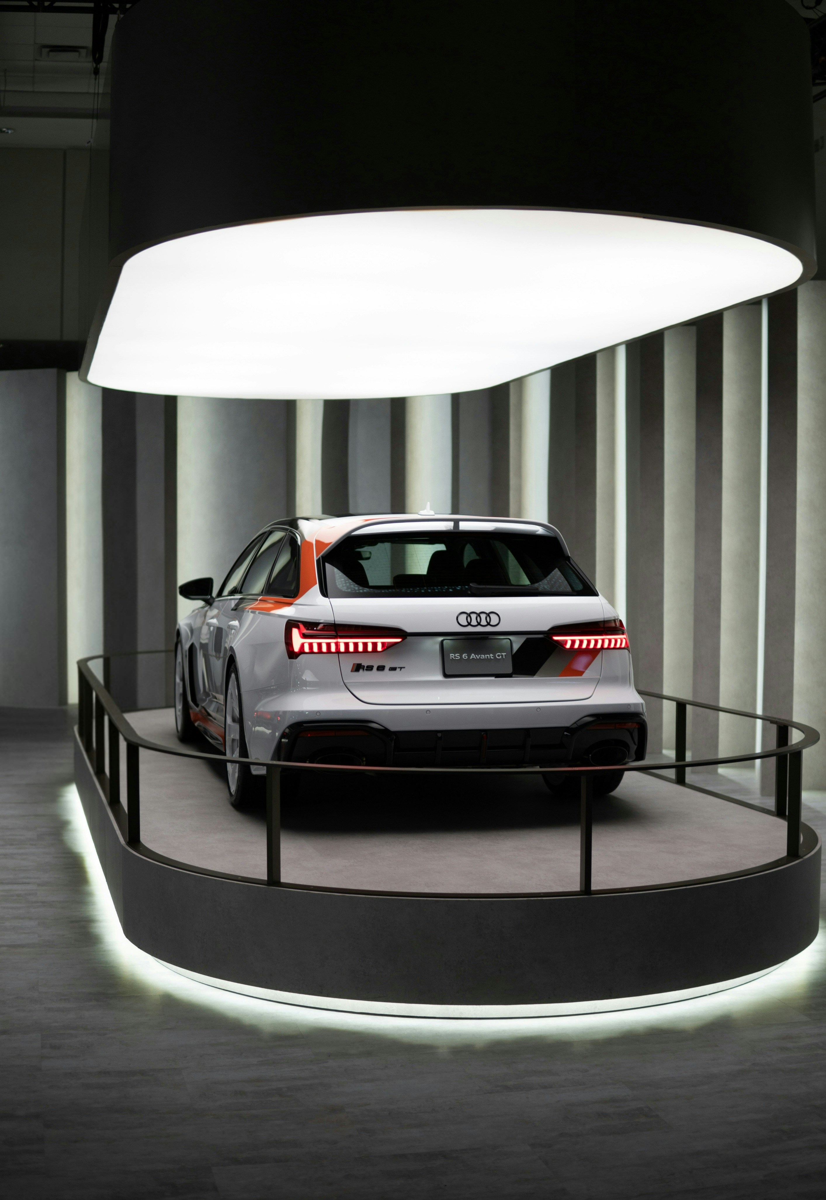 White audi rs6 avant on display with lighting.