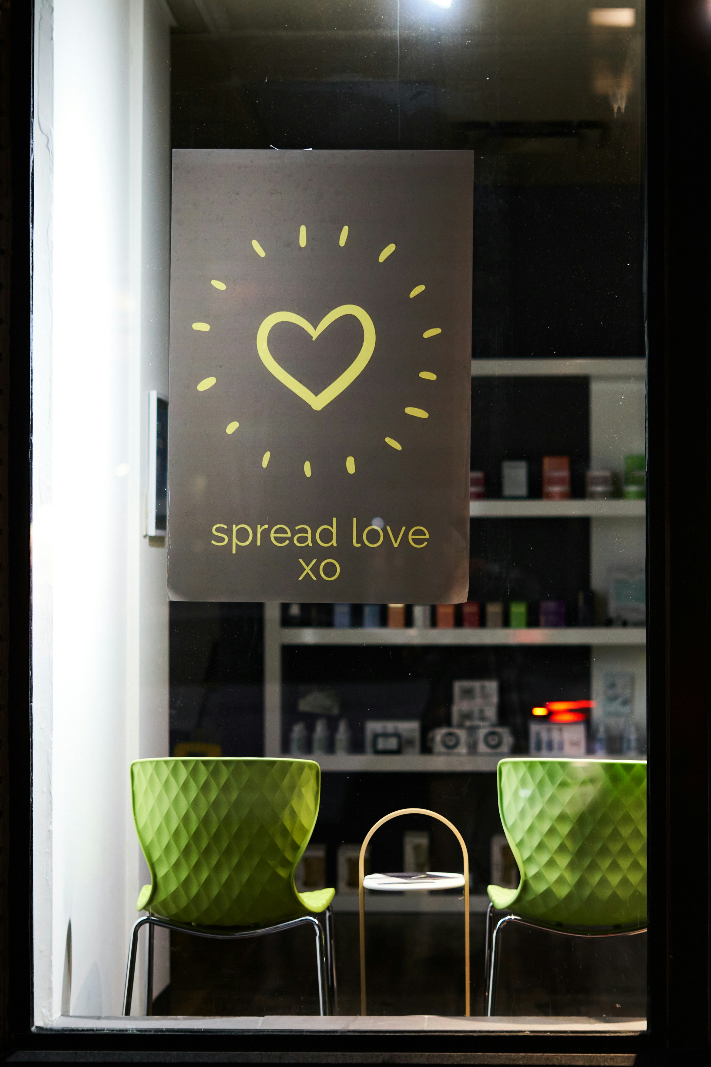 Sign with heart and "spread love xo" text.