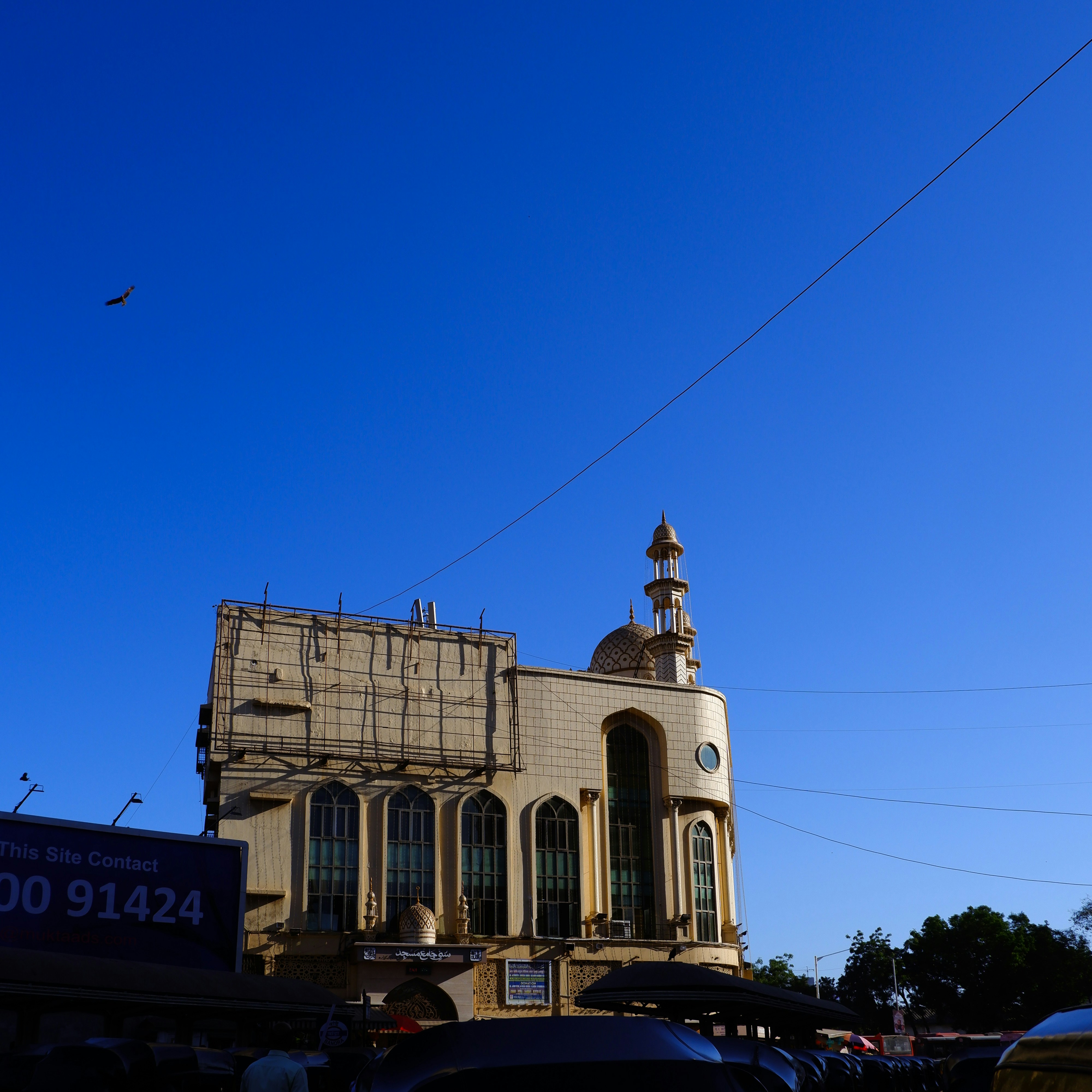 Building with minaret against a clear blue sky