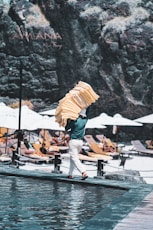 Man carrying towels on a sunny beach resort