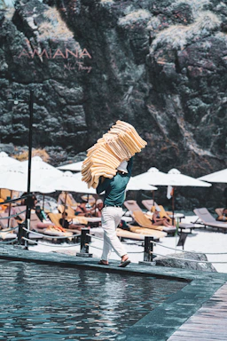 Man carrying towels on a sunny beach resort
