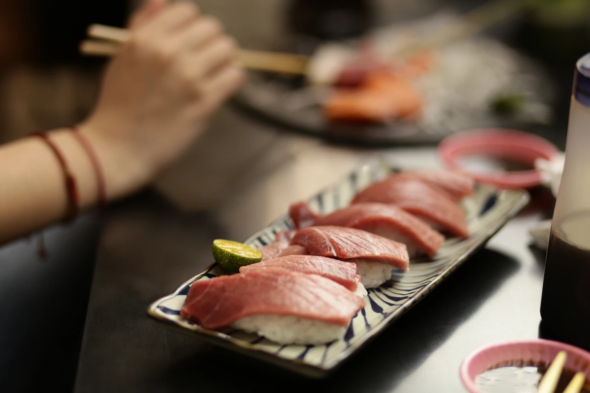 Tuna nigiri sushi with a wedge of lime
