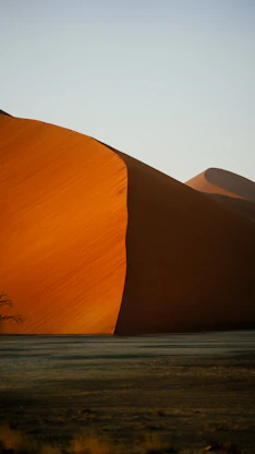 Towering red sand dunes in Sossusvlei in Namibia's Namib Desert