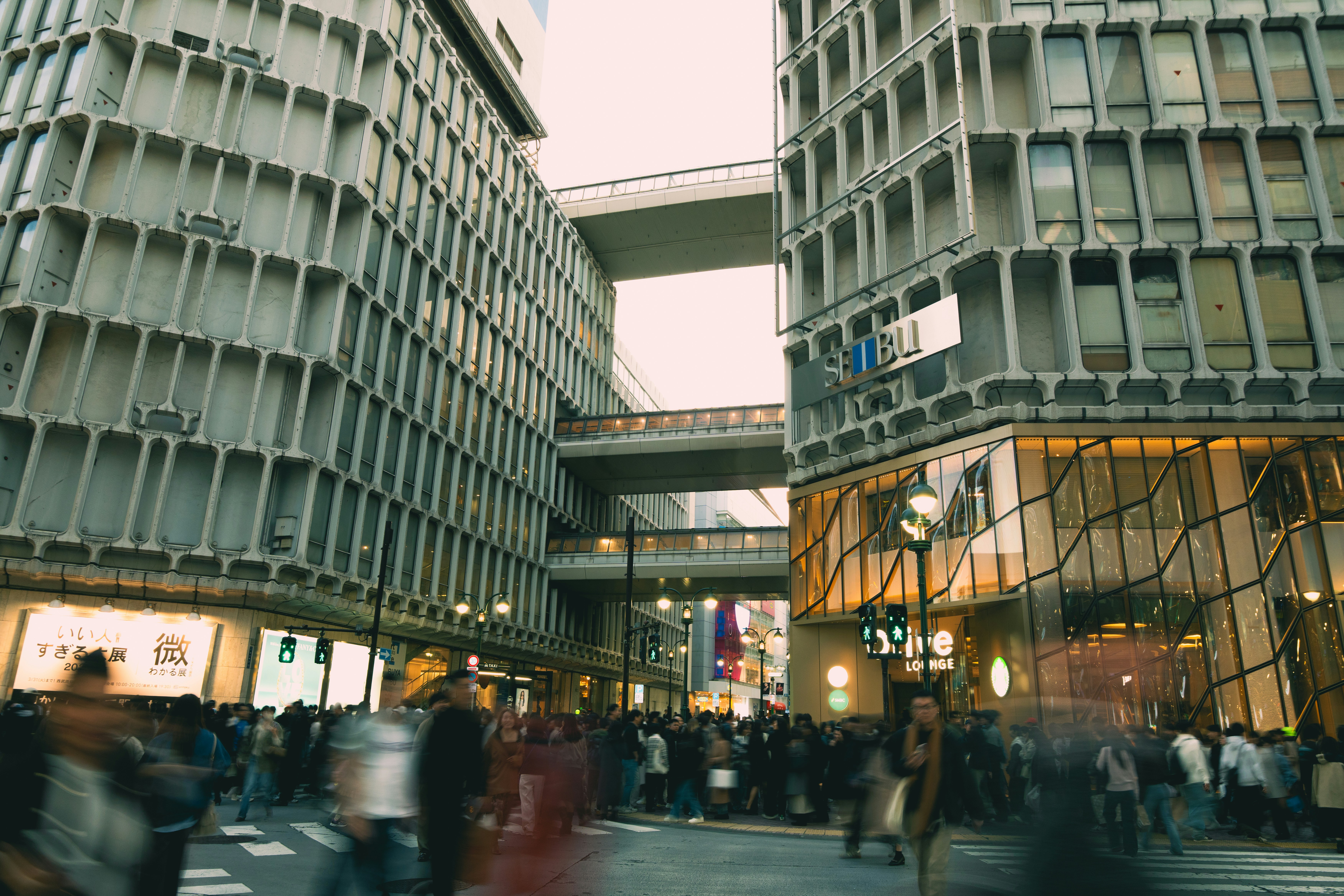 Busy street with blurred pedestrians and modern buildings