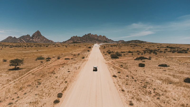 Car driving toward distant mountains
