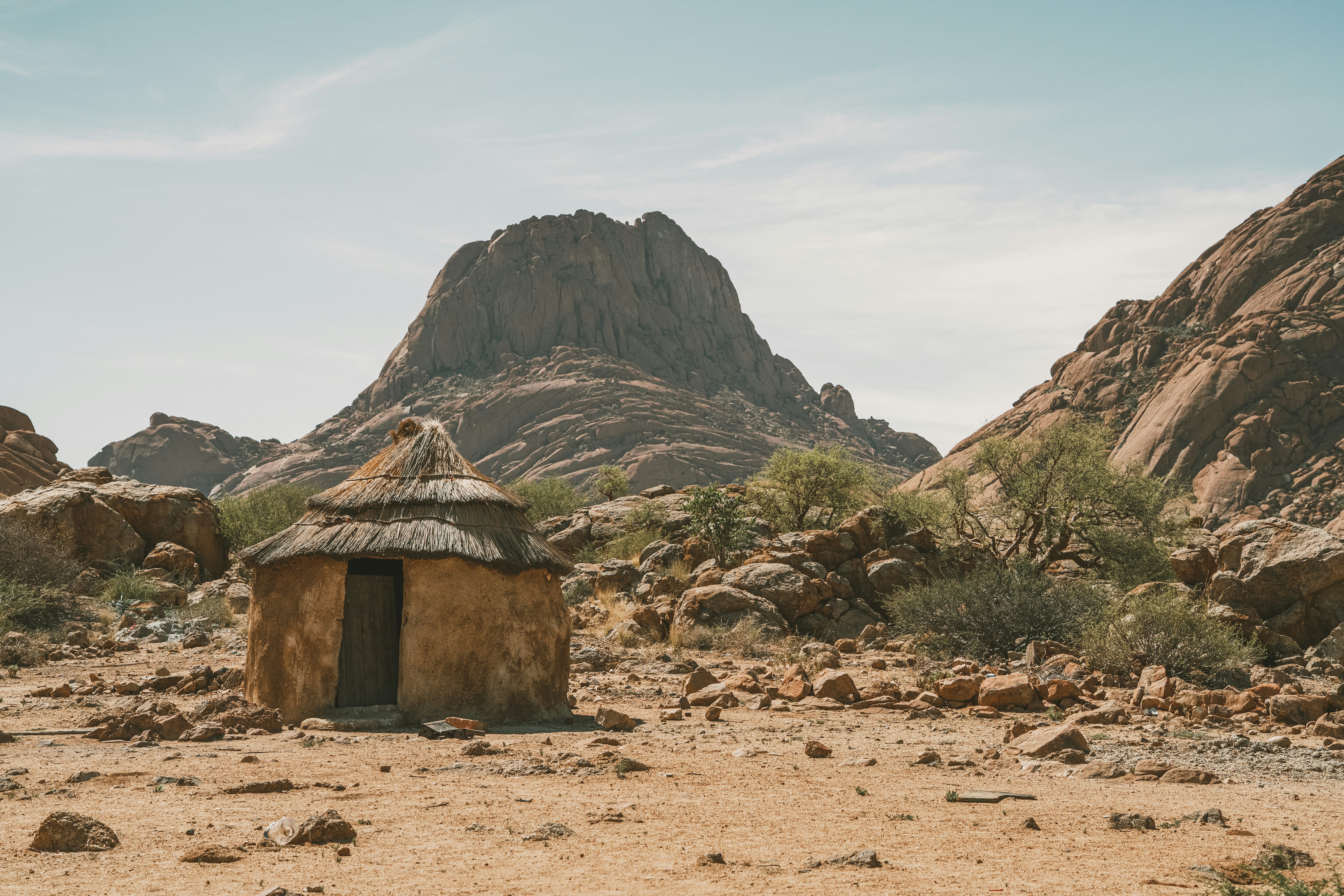 Small round hut in a rocky desert landscape