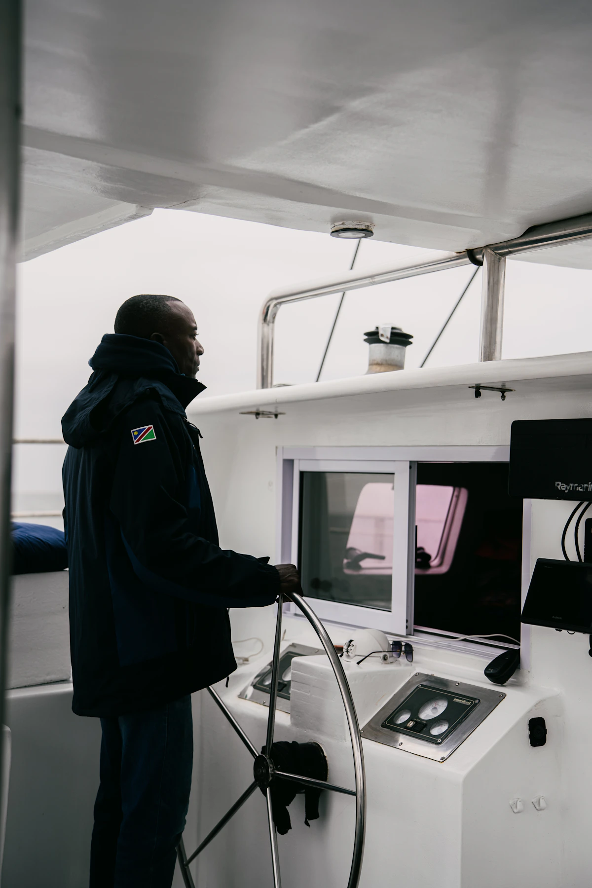 Person operating a boat at the helm