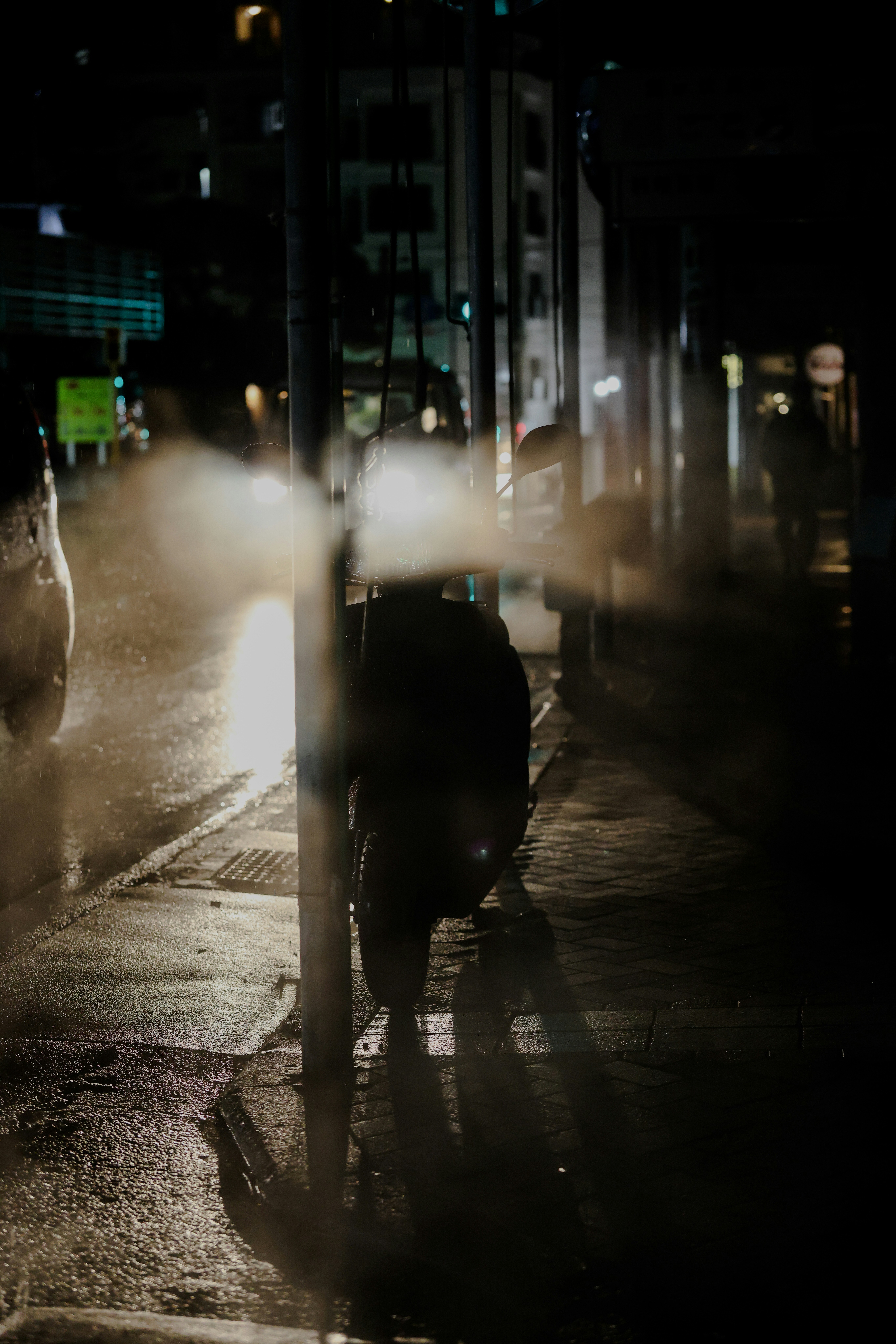 Motorcycle parked on a wet street at night