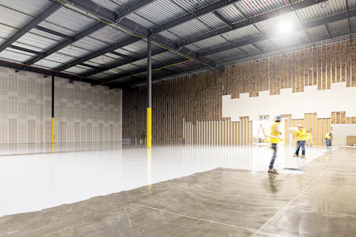 Workers screeding a large warehouse floor