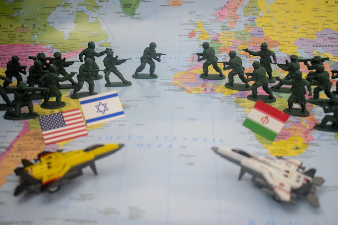 Toy soldiers and flags on world map