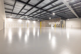 Empty industrial warehouse with polished concrete floor