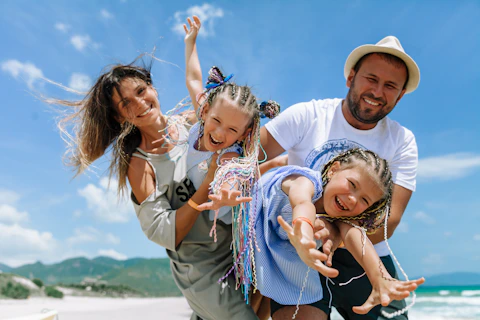 A happy family enjoying a sunny day at the beach. while traveling on a cruise ship