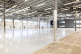 Empty, modern warehouse interior with polished concrete floor.