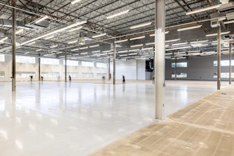 Empty, modern warehouse interior with polished concrete floor.