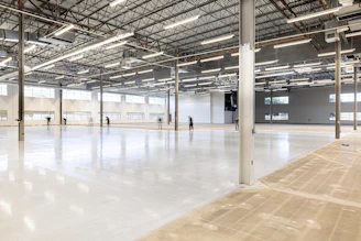 Empty, modern warehouse interior with polished concrete floor.
