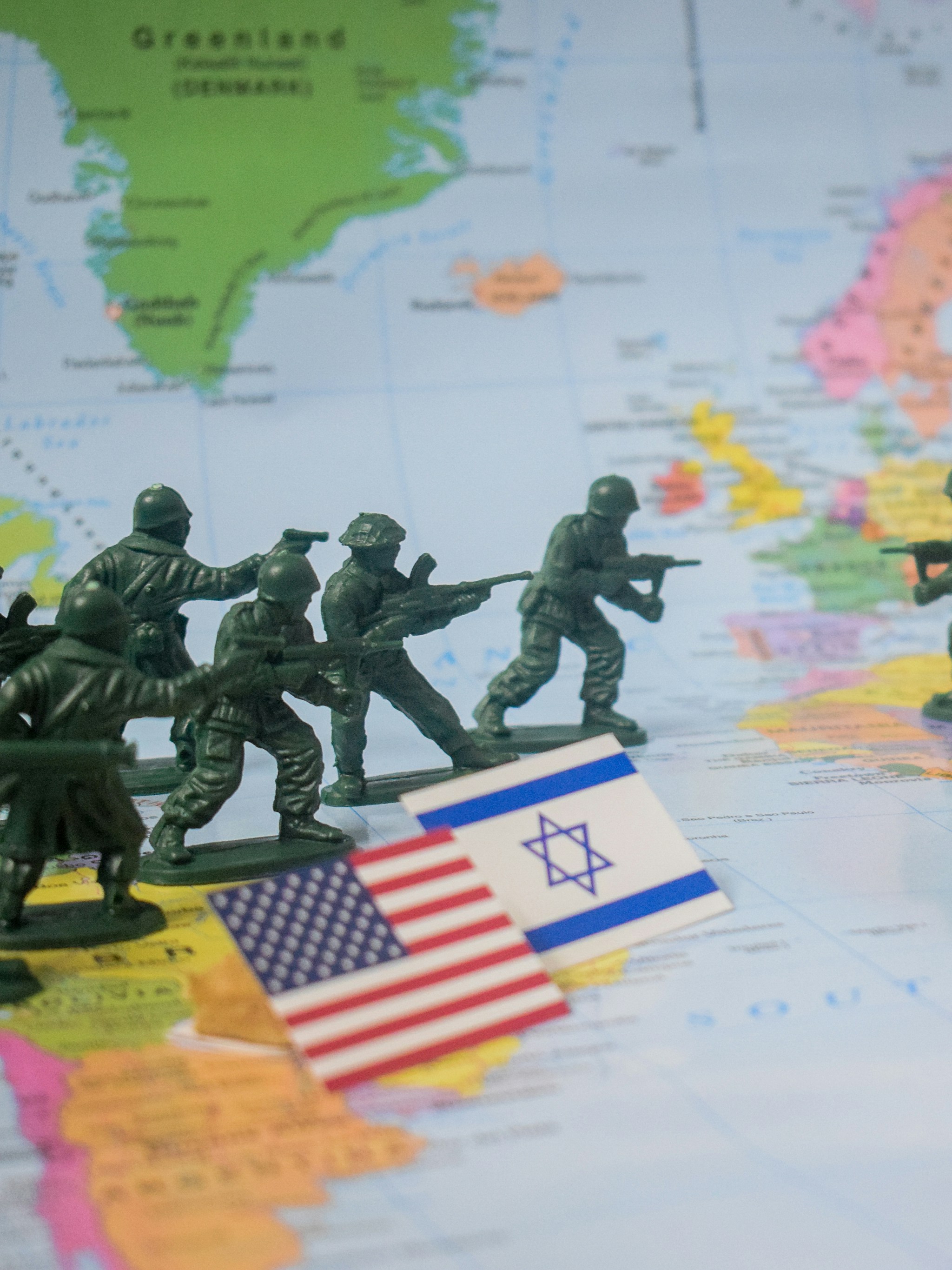 Toy soldiers on world map with flags