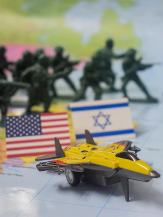 Toy soldiers, flags, and jet on map.