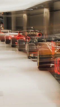 Row of blurred race cars in a museum